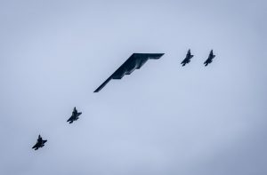 As President Donald Trump greeted Russian President Vladimir Putin on the tarmac at Joint Base Elmendorf-Richardson, a B-2 stealth bomber soared overhead, flanked by four F-35 jets. Putin looked up at the sky as the planes buzzed overhead while he walked alongside Trump, and then made a comment to the U.S. president.