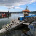 The UK government plans to limit bidding for three new floating docks at HM Naval Base Clyde to British firms, placing a major submarine maintenance project with domestic industry. It has also committed funding for a marine research vessel to be built at a British shipyard, describing the two projects as worth billions of pounds.